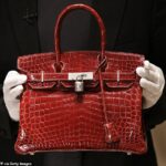 Hermès Birkin bags cost customers tens of thousands of dollars but the bag cost the company just about $1,000 to make, according to analysts. (pictured: A $129,000 crocodile Birkin bag)