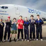 From left to right, Khawlah Ahmad Alharbi, Xuepeng Jiang, Renjie Nie, Hantang Qin, Rayne Wolf, Pengyu Zhang and Jacob Kocemba pose beside G-Force One, the jet in which they tested their zero-gravity 3D printing technique.